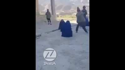 Taliban brutally lashing a woman in Takhar province for going to the shop without a male guardian.