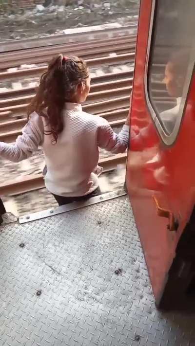 A girl jumping from a Moving train