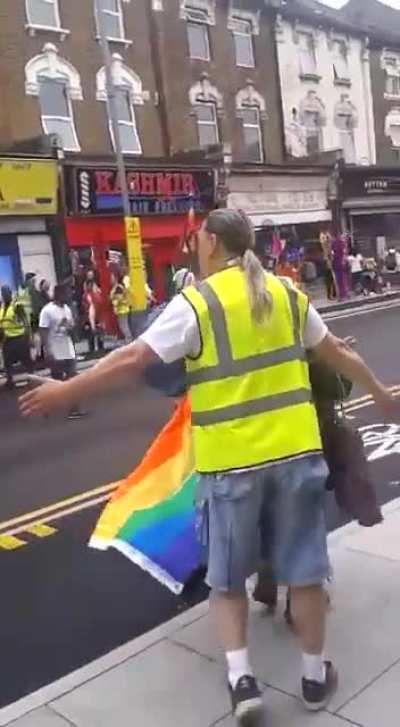 London, England. Woman chases and berates a participant in a pride event