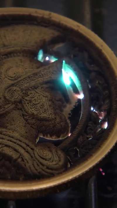 Laser etching reliefs on a coin