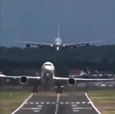 The passenger jet takes of 10 seconds before the plane behind it lands.