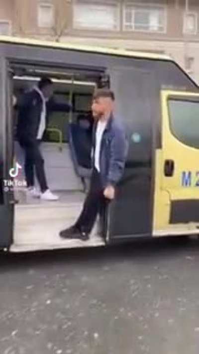 Hanging from the door of a bus