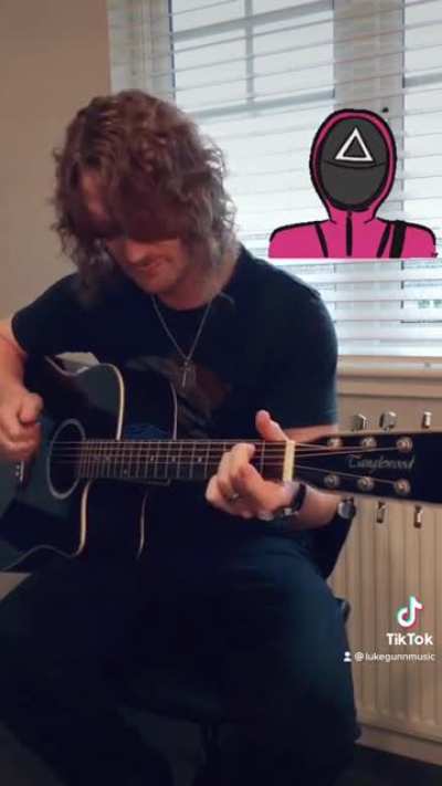 Squid Game theme played on guitar.