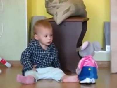 Baby getting scared by a walking toy mouse