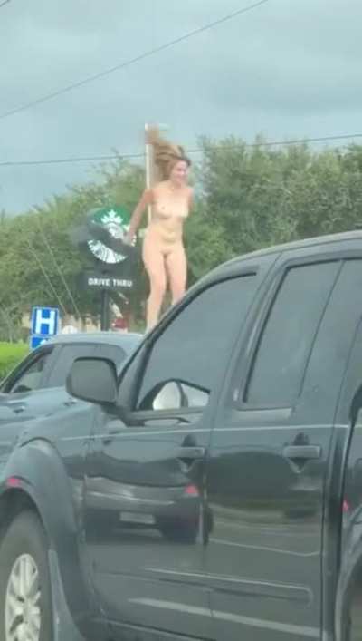 Naked Florida woman gives a show on top of a car.