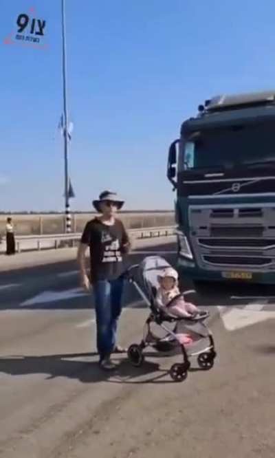 Blocking trucks by placing your baby on the highway