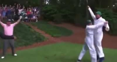 A caddy hits a hole in one in front of Golf Legends