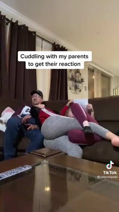 Cuddling with her parents..