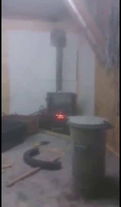 2 dudes putting a spray can in the oven