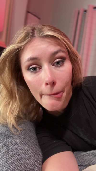 Licking his cum from her lips as she takes a quick selfie
