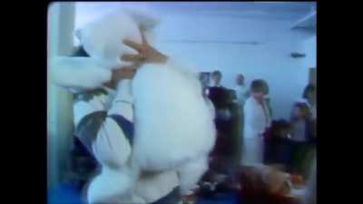 Young Keanu Reeves playing with teddy bear