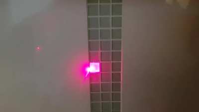 Laser pointer lighting up the glass tiles