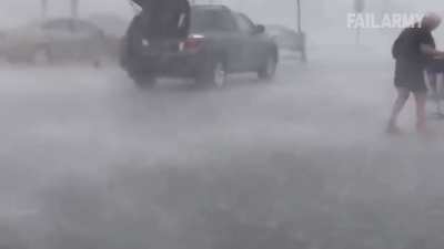 Woman returning shopping cart in severe weather