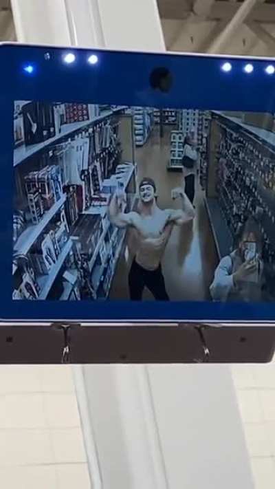 Muscle man flexing in store camera. Cringe or gigachad?