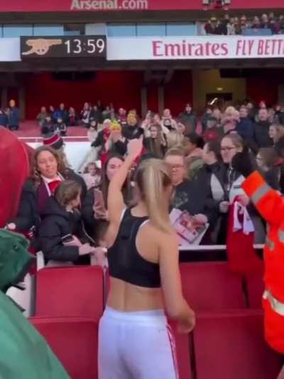 Leah giving her shirt to a fan