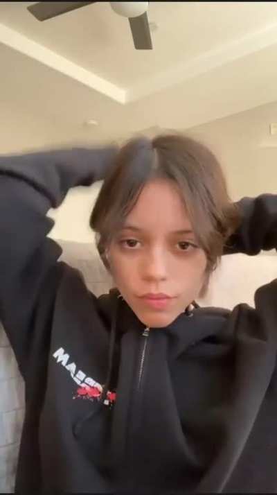 Tying her hair back