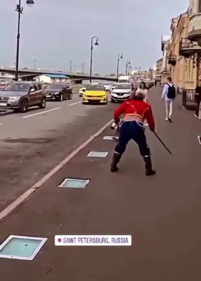 Drunk man in Imperial Russian uniform fights off invisible attackers with sword