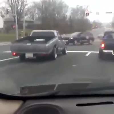 2 bizarro pickup trucks at a stoplight