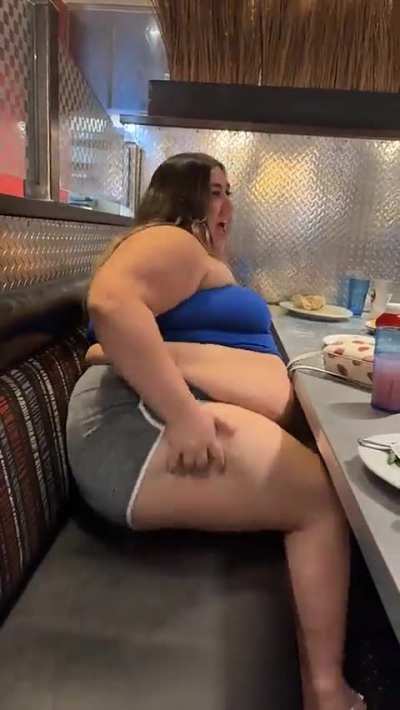 Layla having a hard time getting out of a booth.