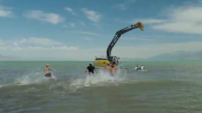 Swinging from a excavator that’s speeding up and then abruptly stops isn’t the brightest idea.