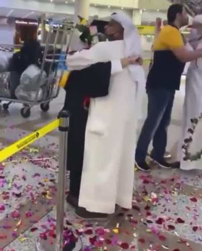 Kuwaiti father celebrating his daughters graduation after studying abroad.
