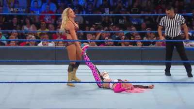 Charlotte chokes poor Liv Morgan out on the ropes and makes her tap out with the figure 8