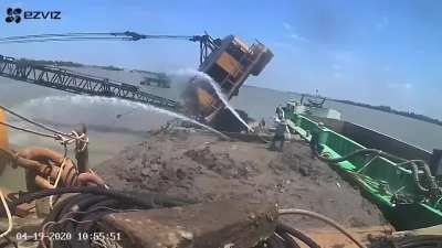 Crane topples while dredging river in Vietnam, September 2020