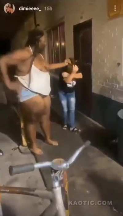 Large woman attacks smaller woman in alley.