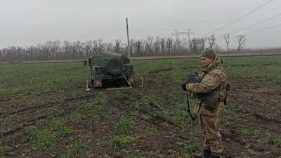 Ukrainian soldier using an improvised MLRS made from B-8 launchers for 80-mm aircraft missiles and installed on the HMMWV. 2022