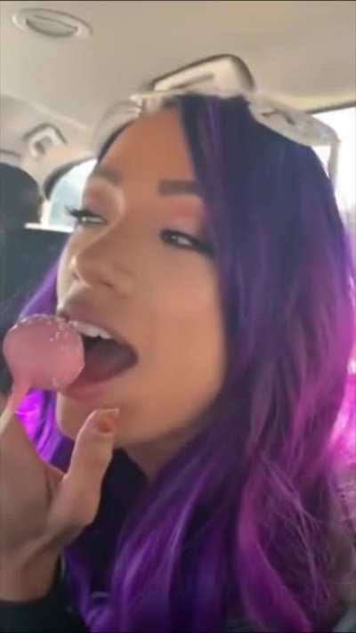 Sasha Banks playing with Bayley's lollipop.