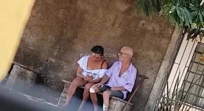 Old guy bangs girl outside on bench