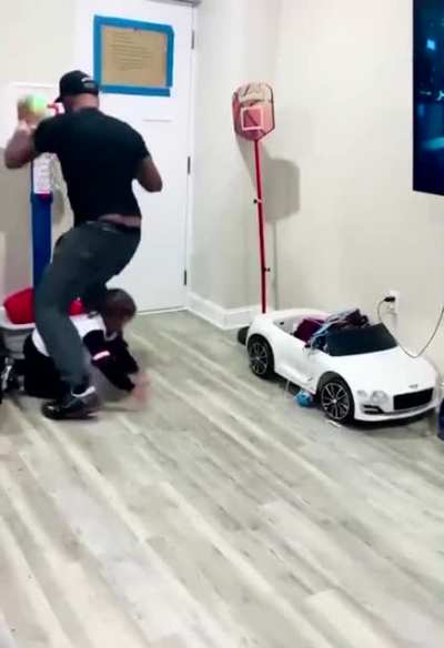 Dad Blocks toddler from shooting a basket and toddler isn’t having any of it