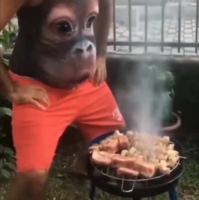 Man needs some help with the grill and his gut is there for him