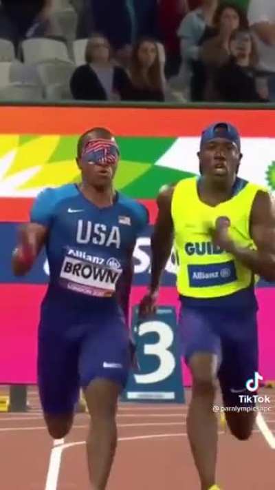 Clip from the Paralympics. David Brown is a blind sprinter, his partner helps keep him on track and cheers him on as they run. 