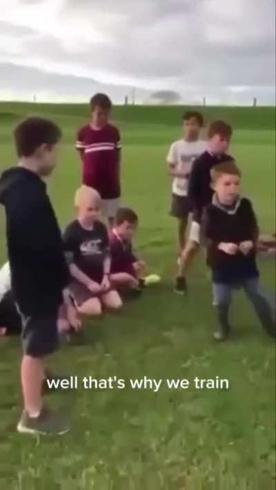 Coach talking to children rugby team about their last game 