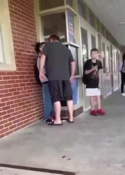 a dad confronts his kid's bully at school.