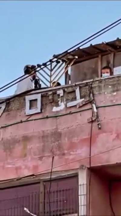 A Woman in Sheikh Jarrah neighborhood, was kicked out of her house forcedly, while zionists enjoy their time on the roof of her house & her standing outside at the doorstep not allowed to enter
