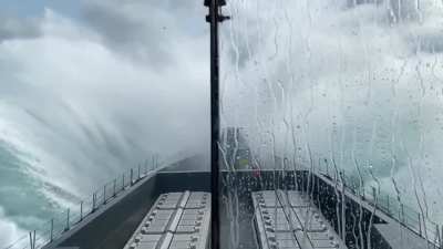 HMS Dauntless crashing through the waves