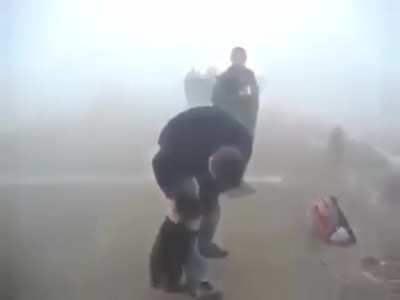 Bear rescued from the forest fire; bear won't let go of his hero.