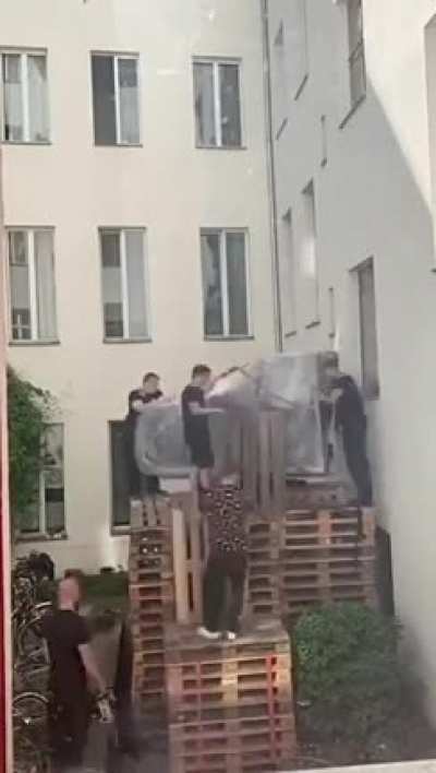 Moving a grand piano to the second floor.