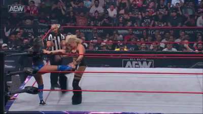 Taya showing Skye Blue no mercy with a hard kick between the legs