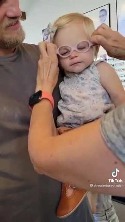 A child gets her first pair of glasses