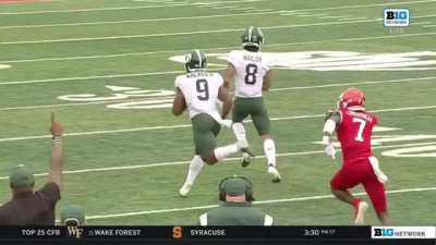 Michigan State runningback Kenneth Walker III shakes hands with his wide receiver during his 94-yard touchdown run