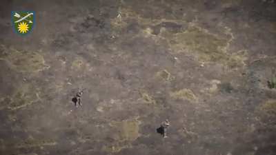 Full video of two Russian soldiers getting harassed by a FPV-drone at close range, one of them throws a stick and misses but in the end he detonates it (close to him) by throwing his weapon at it [September 2024]