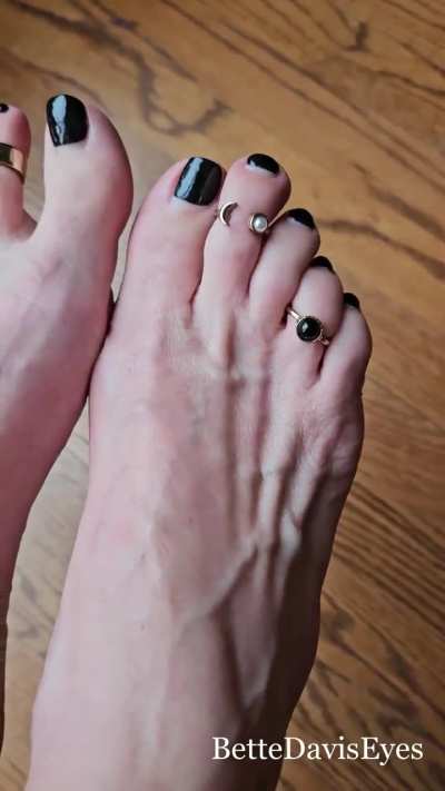 Black polish and toe rings… and always highlighting those longer toes.