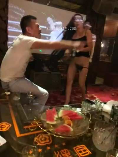 Chinese Waitress serving a bottle of beer