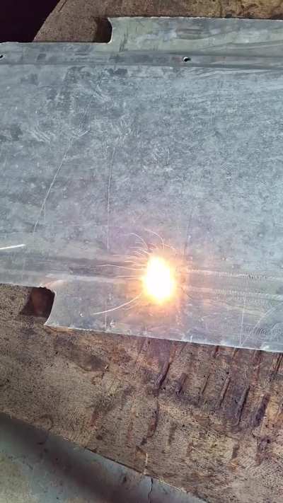 Laser on aluminum's corroded surface. See sparks!