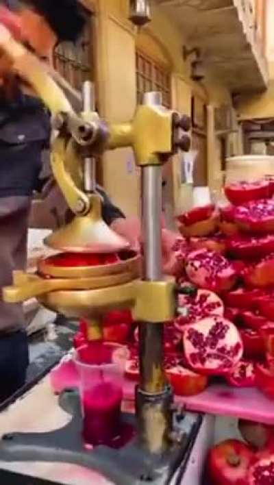 a heavenly elixir of pomegranate juice in the streets of Baghdad, Iraq