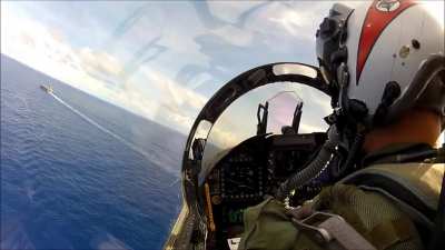 Pilot landing on aircraft carrier