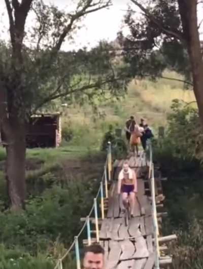 Crossing this rickety bridge on a bike